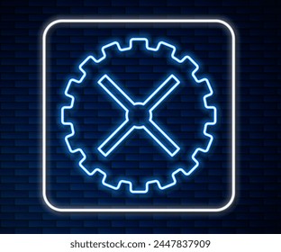 Glowing neon line Bicycle sprocket crank icon isolated on brick wall background.  Vector