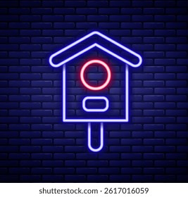 Glowing neon line Bird house icon isolated on brick wall background. Nesting box birdhouse, homemade building for birds. Colorful outline concept. Vector
