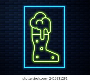 Glowing neon line Boot beer glass icon isolated on brick wall background.  Vector