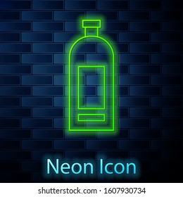 Glowing neon line Bottle of shampoo icon isolated on brick wall background.  Vector Illustration