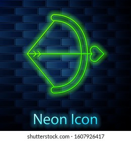 Glowing neon line Bow and arrow icon isolated on brick wall background. Cupid symbol. Love sign. Valentines day concept.  Vector Illustration
