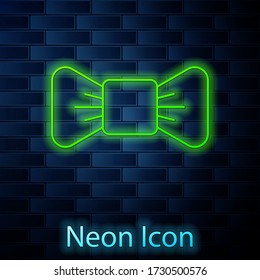 Glowing neon line Bow tie icon isolated on brick wall background. Vector Illustration