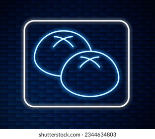 Glowing neon line Bread loaf icon isolated on brick wall background.  Vector