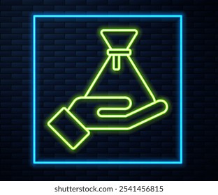 Glowing neon line Bribe money bag icon isolated on brick wall background. Bill currency.  Vector