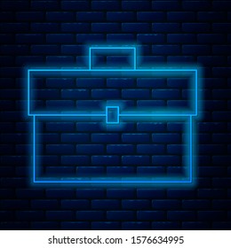 Glowing neon line Briefcase icon isolated on brick wall background. Business case sign. Business portfolio.  Vector Illustration