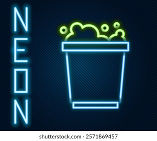 Glowing neon line Bucket with foam and bubbles icon isolated on black background. Cleaning service concept. Colorful outline concept. Vector