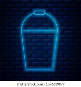 Glowing neon line Bucket icon isolated on brick wall background.  Vector Illustration