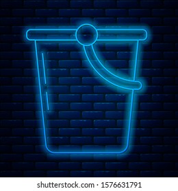 Glowing neon line Bucket icon isolated on brick wall background.  Vector Illustration