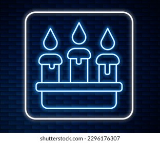 Glowing neon line Burning candle in candlestick icon isolated on brick wall background. Cylindrical candle stick with burning flame.  Vector