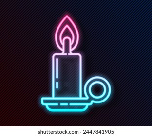 Glowing neon line Burning candle in candlestick icon isolated on black background. Cylindrical candle stick with burning flame.  Vector Illustration