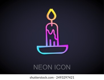 Glowing neon line Burning candle icon isolated on black background. Cylindrical candle stick with burning flame.  Vector