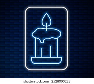 Glowing neon line Burning candle in candlestick icon isolated on brick wall background. Old fashioned lit candle. Cylindrical candle stick with burning flame.  Vector