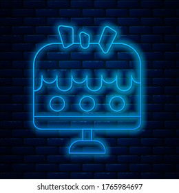 Glowing neon line Cake on plate icon isolated on brick wall background. Happy Birthday.  Vector