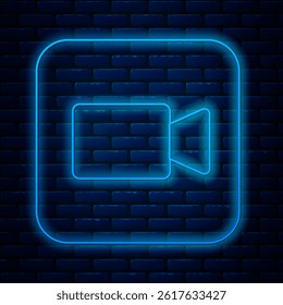 Glowing neon line Camera icon isolated on brick wall background. Video camera. Movie sign. Film projector.  Vector
