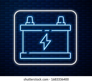 Glowing neon line Car battery icon isolated on brick wall background. Accumulator battery energy power and electricity accumulator battery.  Vector Illustration