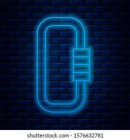 Glowing neon line Carabiner icon isolated on brick wall background. Extreme sport. Sport equipment.  Vector Illustration