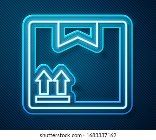 Glowing neon line Cardboard box with traffic symbol icon isolated on blue background. Box, package, parcel. Delivery, transportation and shipping.  Vector Illustration
