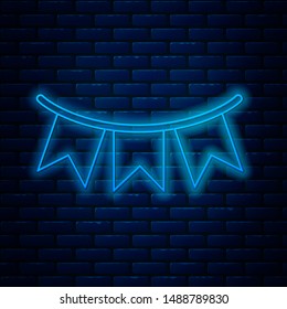 Glowing neon line Carnival garland with flags icon isolated on brick wall background. Party pennants for birthday celebration, festival and fair decoration.  Vector Illustration