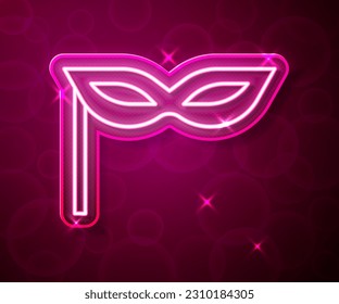 Glowing neon line Carnival mask icon isolated on red background. Masquerade party mask.  Vector