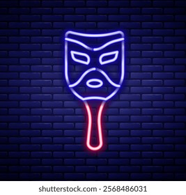 Glowing neon line Carnival mask icon isolated on brick wall background. Masquerade party mask. Colorful outline concept. Vector