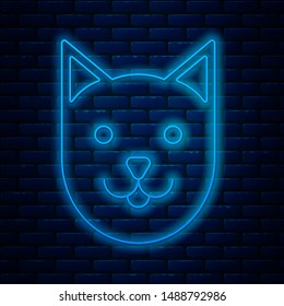 Glowing neon line Cat icon isolated on brick wall background.  Vector Illustration