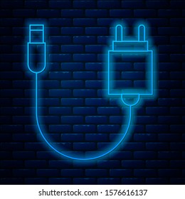 Glowing neon line Charger icon isolated on brick wall background.  Vector Illustration