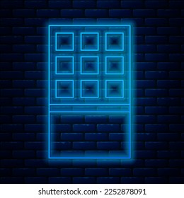 Glowing neon line Chocolate bar icon isolated on brick wall background.  Vector