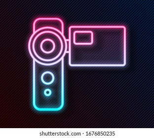 Glowing neon line Cinema camera icon isolated on black background. Video camera. Movie sign. Film projector.  Vector Illustration
