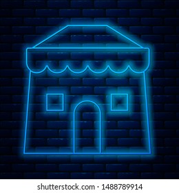 Glowing neon line Circus tent icon isolated on brick wall background. Carnival camping tent. Amusement park.  Vector Illustration