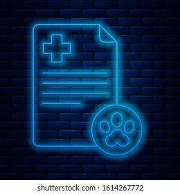 Glowing neon line Clipboard with medical clinical record pet icon isolated on brick wall background. Health insurance form. Medical check marks report.  Vector Illustration