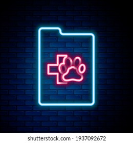 Glowing neon line Clipboard with medical clinical record pet icon isolated on brick wall background. Health insurance form. Medical check marks report. Colorful outline concept. Vector
