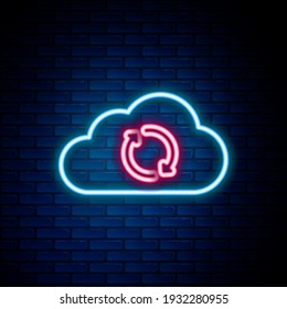 Glowing neon line Cloud sync refresh icon isolated on brick wall background. Cloud and arrows. Colorful outline concept. Vector
