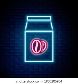 Glowing neon line Coffee beans in bag icon isolated on brick wall background. Colorful outline concept. Vector