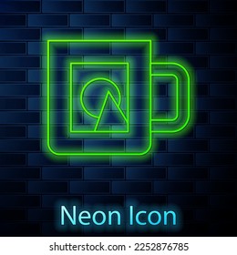 Glowing neon line Coffee cup icon isolated on brick wall background. Take away print.  Vector