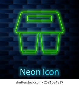 Glowing neon line Coffee cup to go icon isolated on brick wall background.  Vector