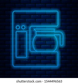 Glowing neon line Coffee machine with glass pot icon isolated on brick wall background.  Vector Illustration