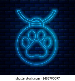 Glowing neon line Collar with name tag icon isolated on brick wall background. Supplies for domestic animal. Dog or cat paw print. Cat and dog care. Pet chains.  Vector Illustration