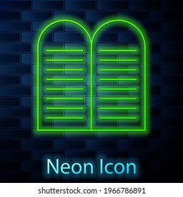 Glowing neon line The commandments icon isolated on brick wall background. Gods law concept.  Vector