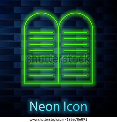 Glowing neon line The commandments icon isolated on brick wall background. Gods law concept.  Vector