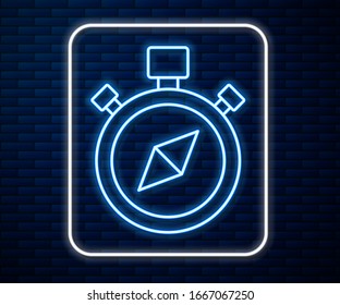 Glowing neon line Compass icon isolated on brick wall background. Windrose navigation symbol. Wind rose sign.  Vector Illustration