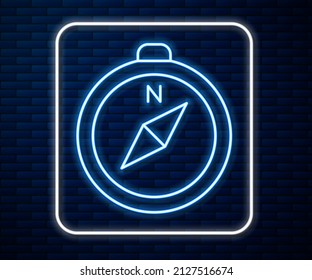 Glowing neon line Compass icon isolated on brick wall background. Windrose navigation symbol. Wind rose sign.  Vector