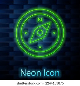 Glowing neon line Compass icon isolated on brick wall background. Windrose navigation symbol. Wind rose sign.  Vector