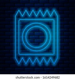 Glowing neon line Condom in package icon isolated on brick wall background. Safe love symbol. Contraceptive method for male.  Vector Illustration