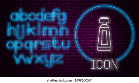 Glowing neon line Cream or lotion cosmetic tube icon isolated on brick wall background. Body care products for men. Neon light alphabet. Vector Illustration
