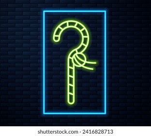 Glowing neon line Crook icon isolated on brick wall background. Ancient Egypt symbol. Scepters of egypt.  Vector