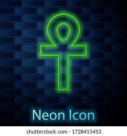 Glowing neon line Cross ankh icon isolated on brick wall background. Vector Illustration