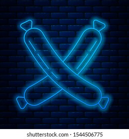 Glowing neon line Crossed sausage icon isolated on brick wall background. Grilled sausage and aroma sign.  Vector Illustration