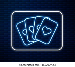 Glowing neon line Deck of playing cards icon isolated on brick wall background. Casino gambling.  Vector Illustration