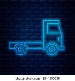 Glowing neon line Delivery cargo truck vehicle icon isolated on brick wall background.  Vector Illustration