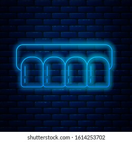 Glowing neon line Dentures model icon isolated on brick wall background. Teeth of the upper jaw. Dental concept.  Vector Illustration
